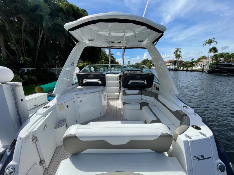 Slide: The Image of 2016 Monterey 335 Sport Yacht on a scenic waterway, featuring spacious seating and sleek design. - 3