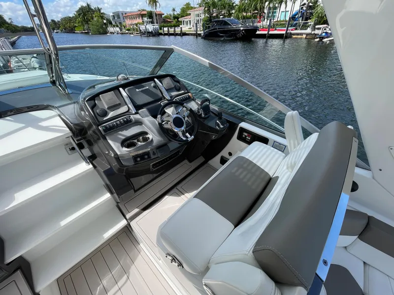 Slide: The Image of 2016 Monterey 335 Sport Yacht cockpit with modern controls and waterfront view. - 6