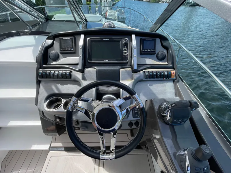 Slide: The Image of 2016 Monterey 335 Sport Yacht dashboard with modern controls and steering wheel. - 7