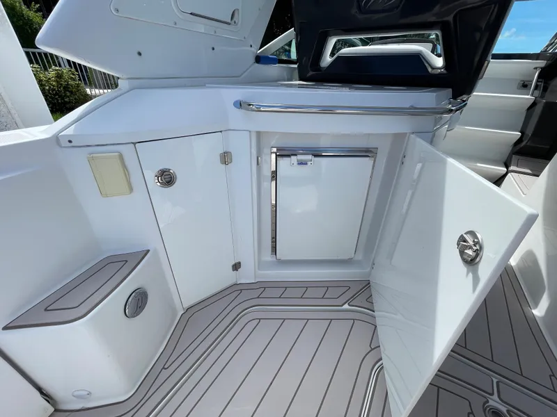 Slide: The Image of 2016 Monterey 335 Sport Yacht interior with open storage compartments and sleek design. - 8