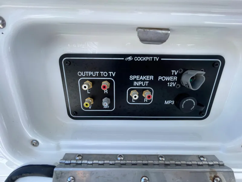 Slide: The Image of Monterey 335 Sport Yacht 2016 cockpit TV control panel with audio and power inputs. - 9