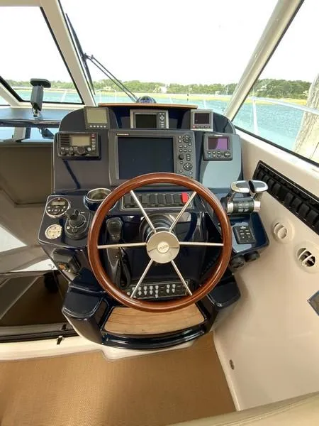 Slide: The Image of Tiara Yachts 36 helm, 2013 model, featuring advanced navigation controls and wooden steering wheel. - 16