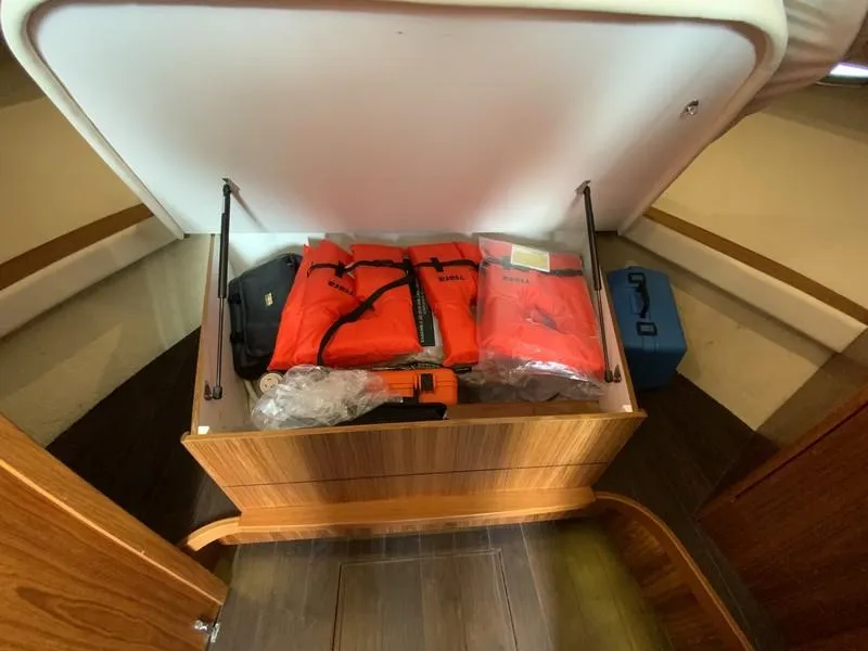 Slide: The Image of Storage compartment in 2013 Tiara Yachts 36, containing life jackets and safety equipment. - 19