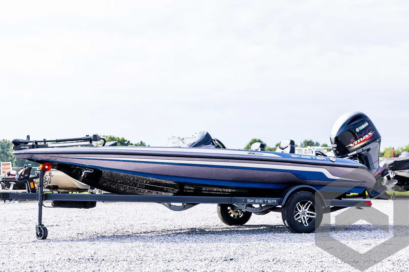 Slide: The Image of 2025 Skeeter ZX 150 boat on trailer, side view, outdoors. - 1