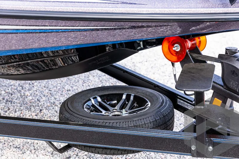 Slide: The Image of 2025 Skeeter ZX 150 boat trailer with spare tire and winch detail. - 11