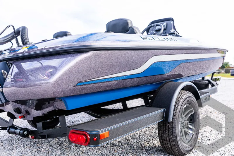 Slide: The Image of 2025 Skeeter ZX 150 boat on trailer, sleek design with blue accents. - 13
