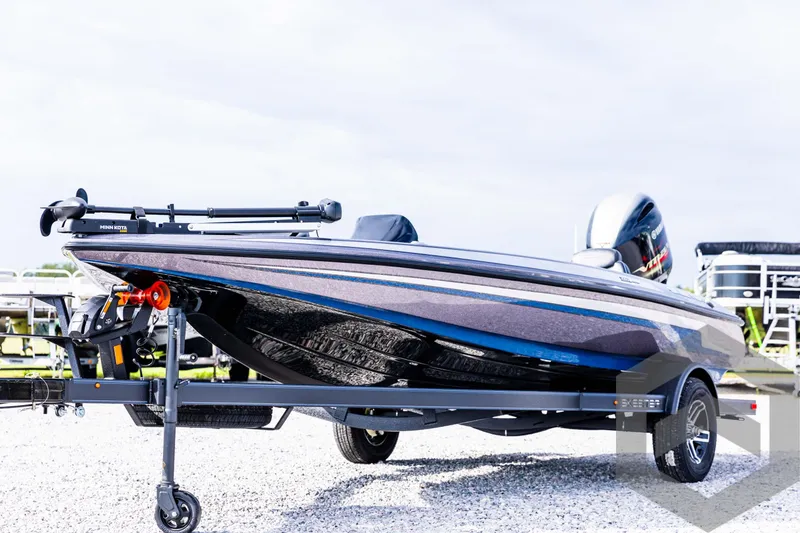 Slide: The Image of 2025 Skeeter ZX 150 boat on trailer, sleek design, parked outdoors. - 2