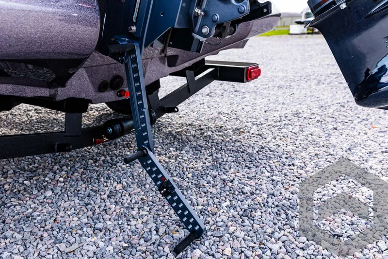 Slide: The Image of 2025 Skeeter ZX 150 boat trailer on gravel with step ladder. - 25