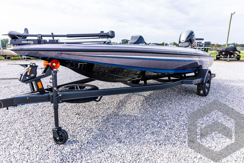 Slide: The Image of 2025 Skeeter ZX 150 boat on trailer, parked on gravel lot. - 27