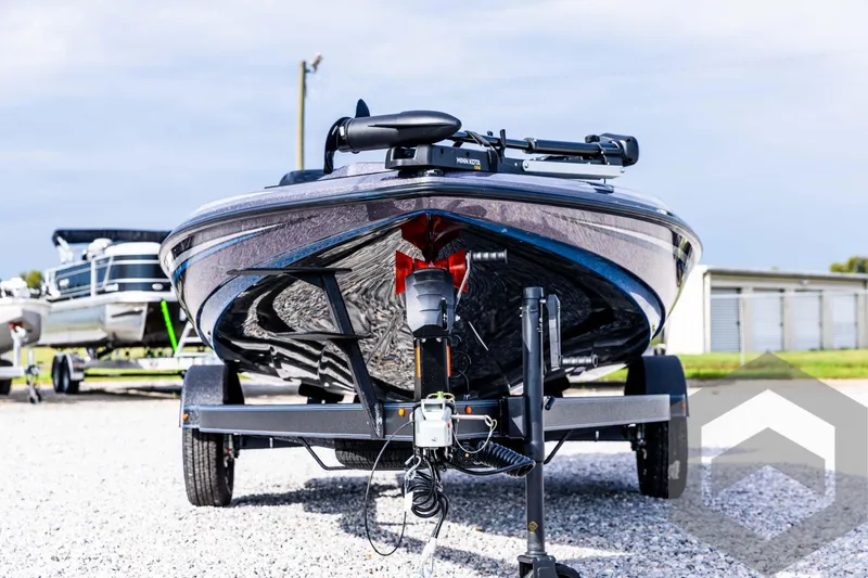 Slide: The Image of 2025 Skeeter ZX 150 boat on trailer, front view, parked on gravel. - 3
