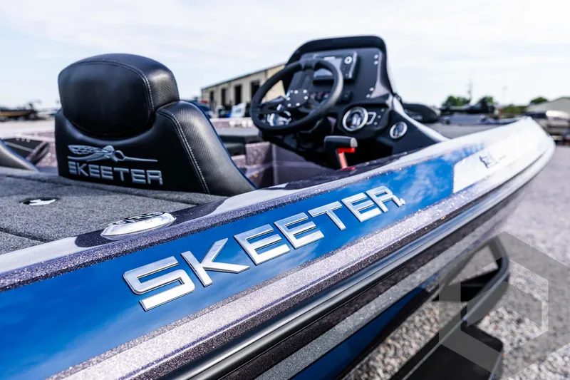 Slide: The Image of 2025 Skeeter ZX 150 boat, close-up of sleek blue design and steering console. - 33