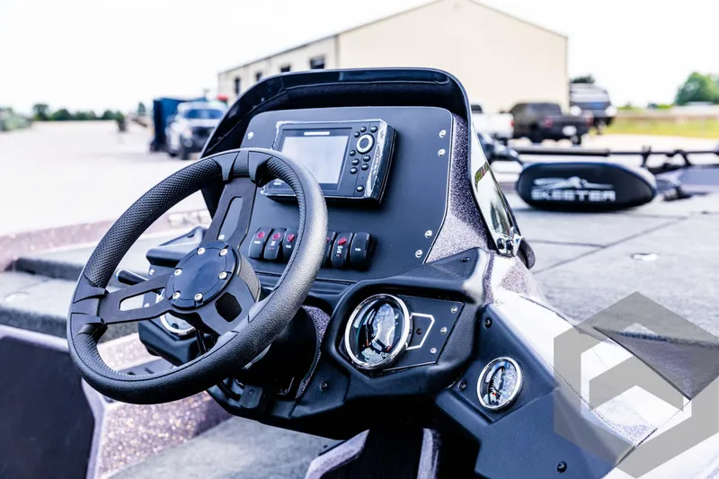 Slide: The Image of 2025 Skeeter ZX 150 boat dashboard with steering wheel and control panel. - 34