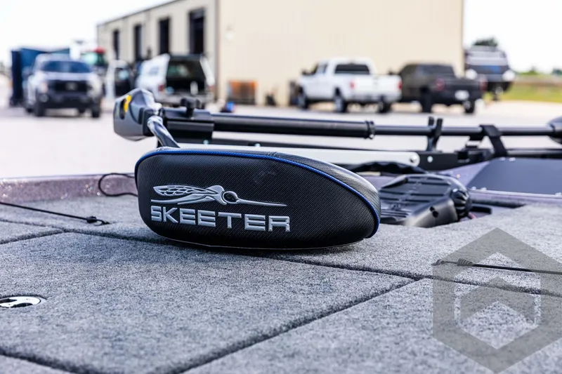 Slide: The Image of 2025 Skeeter ZX 150 boat deck with logo, parked in a lot. - 35