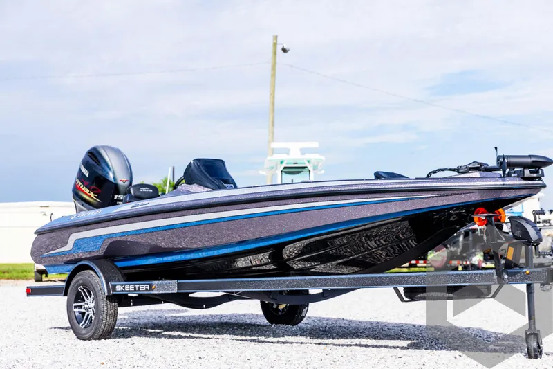 Slide: The Image of 2025 Skeeter ZX 150 boat on trailer, sleek design, outdoor setting. - 4