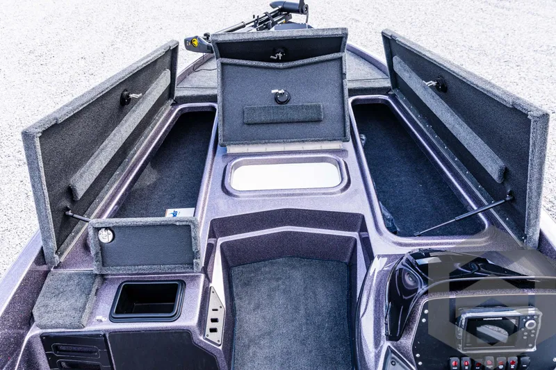 Slide: The Image of 2025 Skeeter ZX 150 boat interior with open storage compartments and control panel. - 44