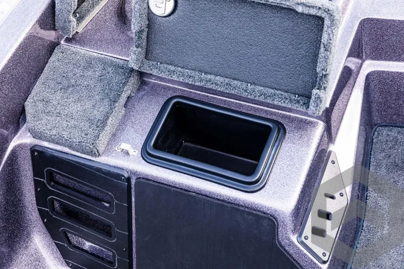 Slide: The Image of 2025 Skeeter ZX 150 boat storage compartment with open lid and carpeted interior. - 45