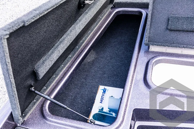 Slide: The Image of Open storage compartment in 2025 Skeeter ZX 150 boat with manual inside. - 46