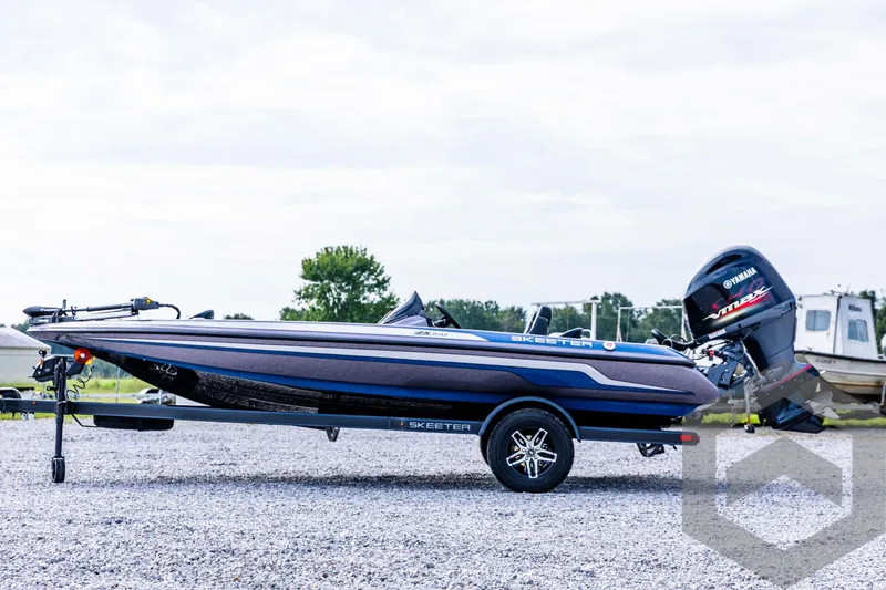Slide: The Image of 2025 Skeeter ZX 150 boat on trailer, parked outdoors. - 9