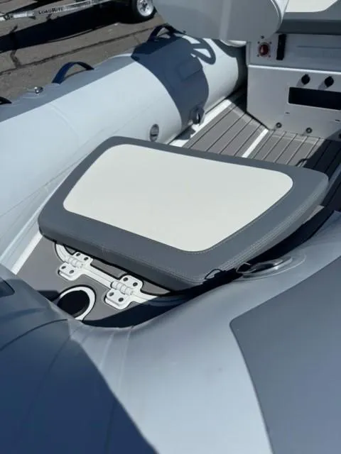 Slide: The Image of 2024 Highfield Classic 310 FCT boat interior with cushioned seating and control panel. - 5