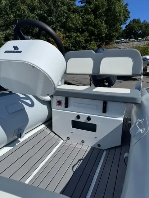 Slide: The Image of 2024 Highfield Classic 310 FCT boat interior with steering console and seating. - 6