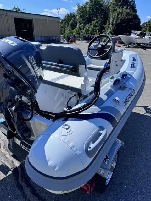 Slide: The Image of 2024 Highfield Classic 310 FCT inflatable boat with Yamaha engine, parked outdoors. - 7