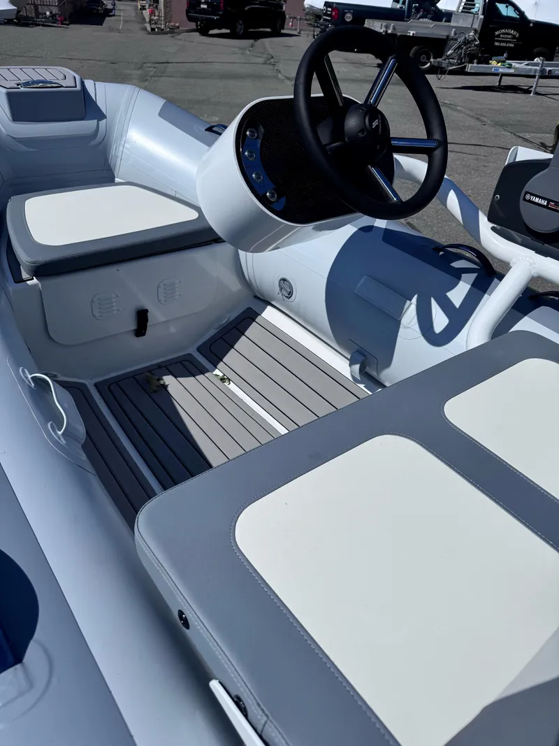 Slide: The Image of 2024 Highfield Classic 310 FCT boat interior with steering wheel and seating. - 9