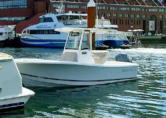 Slide: The Image of 2020 Regulator 23 FS boat docked in a marina with other vessels. - 13