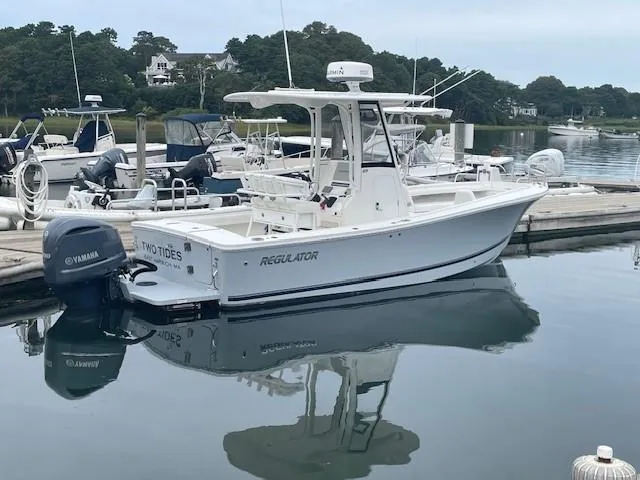 Slide: The Image of 2020 Regulator 23 FS boat docked with Yamaha outboard motor. - 2