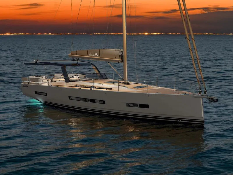 Slide: The Image of 2025 Hanse 590 yacht sailing at sunset on calm waters. - 22