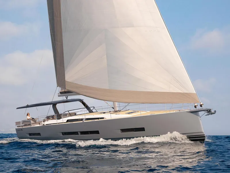 Slide: The Image of 2025 Hanse 590 yacht sailing on open sea under clear skies. - 12