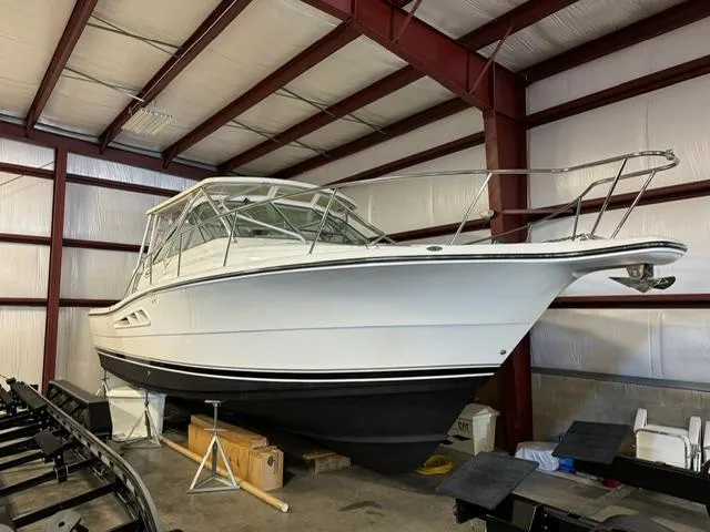 Slide: The Image of 2006 Rampage 33 Express boat stored indoors, showcasing sleek design and sturdy build. - 0