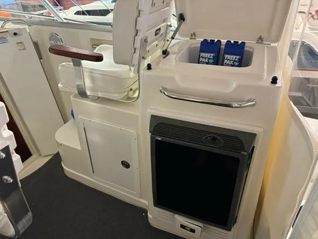 Slide: The Image of 2006 Rampage 33 Express boat interior with cooler and storage compartments. - 10