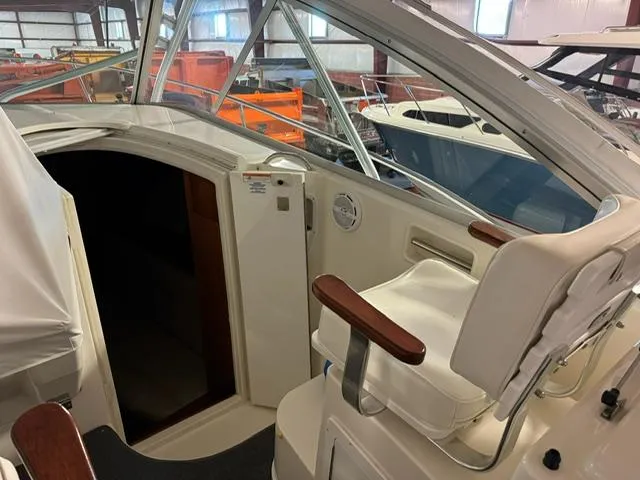 Slide: The Image of 2006 Rampage 33 Express boat interior with helm seat and cabin entrance. - 11