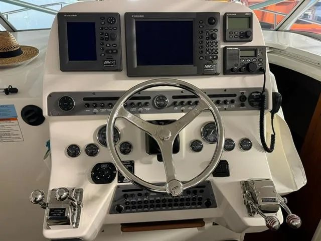 Slide: The Image of 2006 Rampage 33 Express helm with navigation controls and steering wheel. - 12