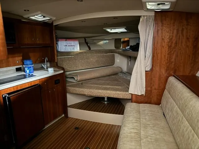 Slide: The Image of Interior of 2006 Rampage 33 Express boat with kitchenette and seating area. - 17