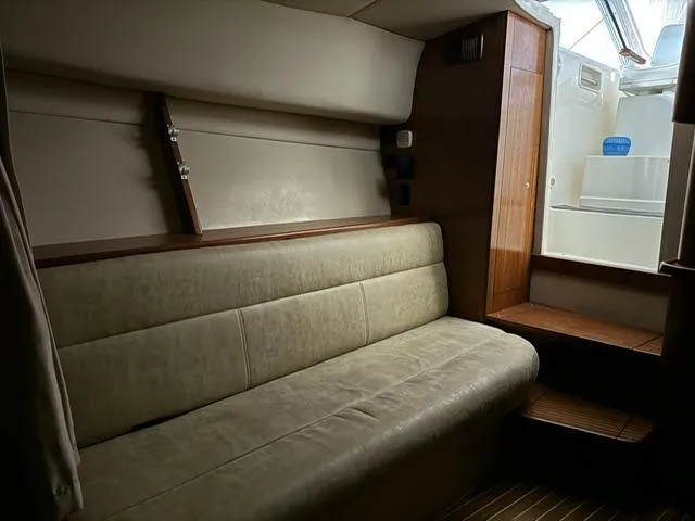 Slide: The Image of Interior of 2006 Rampage 33 Express boat with beige seating and wooden accents. - 18