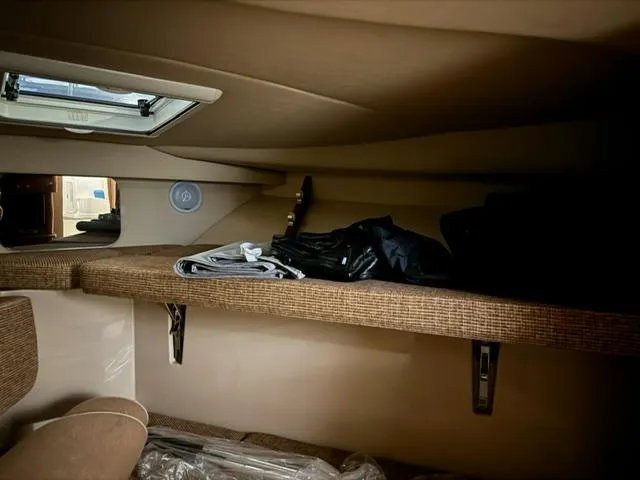 Slide: The Image of Interior cabin storage of 2006 Rampage 33 Express boat with folded clothes. - 19