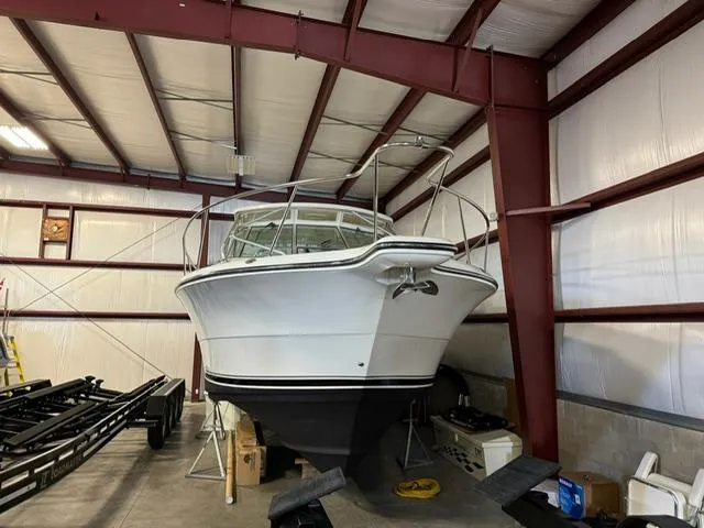 Slide: The Image of 2006 Rampage 33 Express boat stored in a metal warehouse. - 2