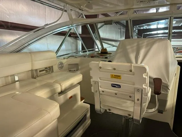 Slide: The Image of 2006 Rampage 33 Express boat interior with white seating and helm station. - 8
