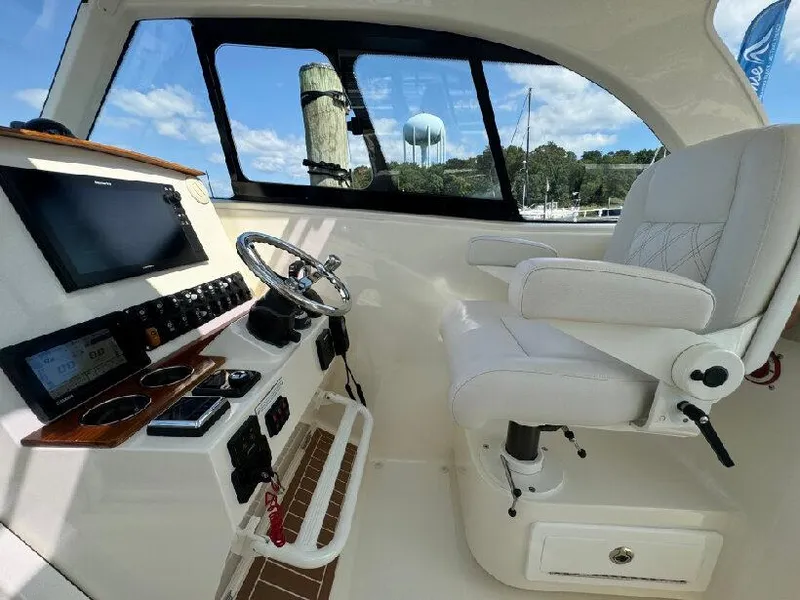 Slide: The Image of Interior of 2019 Southport 33 DC boat with helm and captain's chair. - 10