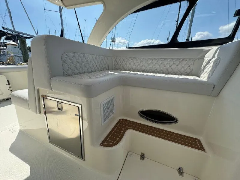 Slide: The Image of 2019 Southport 33 DC boat interior with cushioned seating and storage compartment. - 12