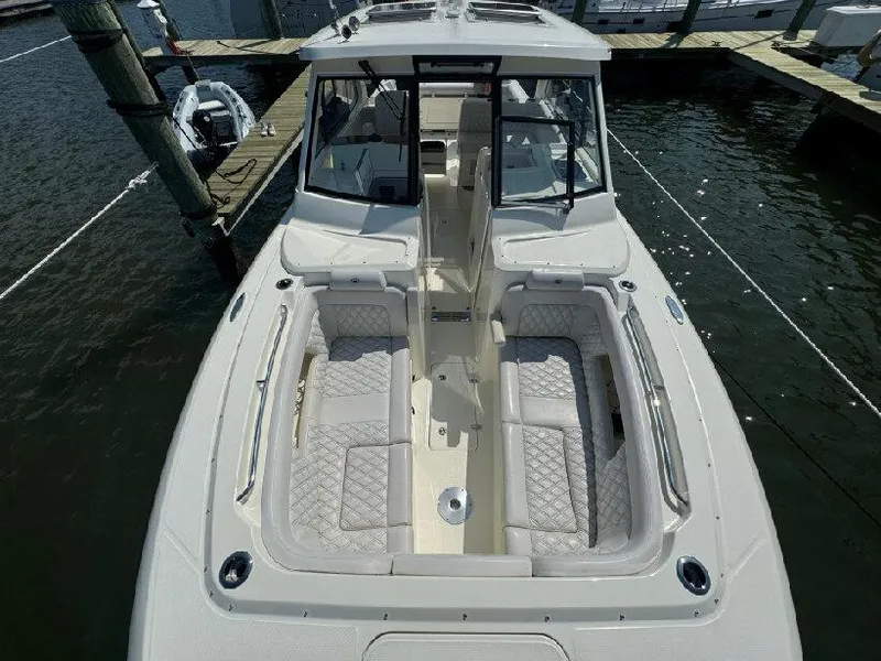 Slide: The Image of 2019 Southport 33 DC boat with spacious seating, docked at marina. - 15