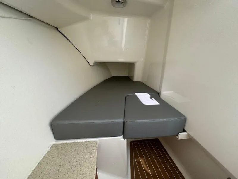 Slide: The Image of 2019 Southport 33 DC cabin interior with cushioned seating and wooden flooring. - 17