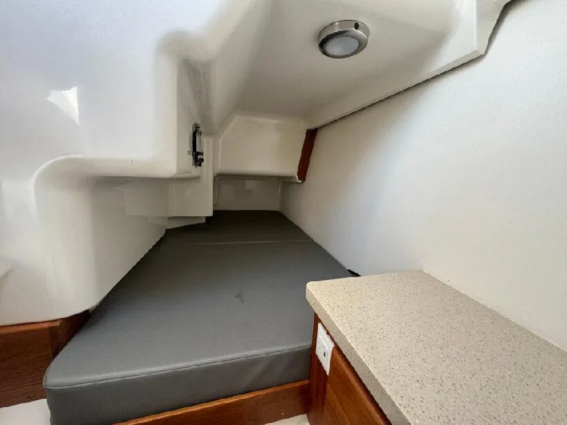Slide: The Image of 2019 Southport 33 DC cabin interior with cushioned berth and modern lighting. - 18