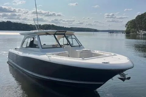 Slide: The Image of 2019 Southport 33 DC boat on calm lake with scenic background. - 3