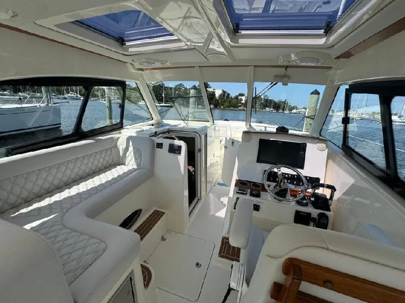 Slide: The Image of Interior of 2019 Southport 33 DC boat with luxurious seating and modern dashboard. - 8