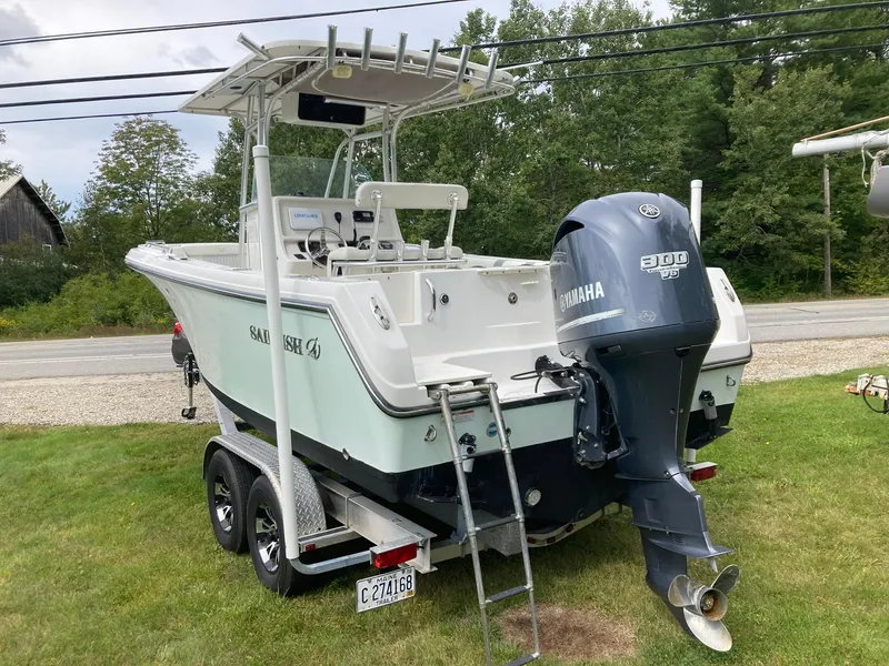 Slide: The Image of 2011 Sailfish 2360 CC boat with Yamaha engine on trailer, parked on grass. - 4