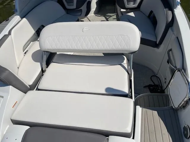 Slide: The Image of 2023 Crownline 290 XSS boat interior with white cushioned seating. - 15