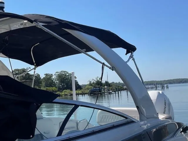Slide: The Image of 2023 Crownline 290 XSS boat docked on a serene lake. - 17