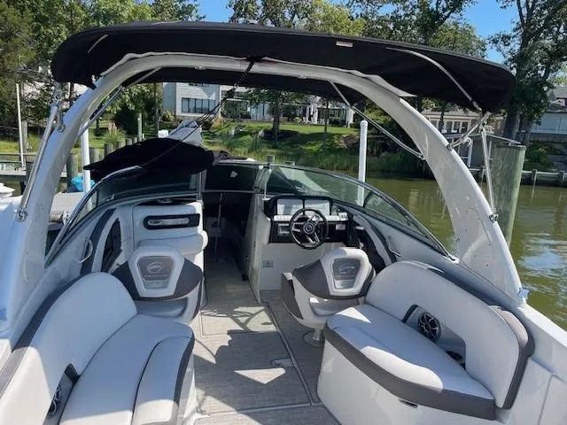 Slide: The Image of 2023 Crownline 290 XSS boat interior with seating and steering wheel. - 18